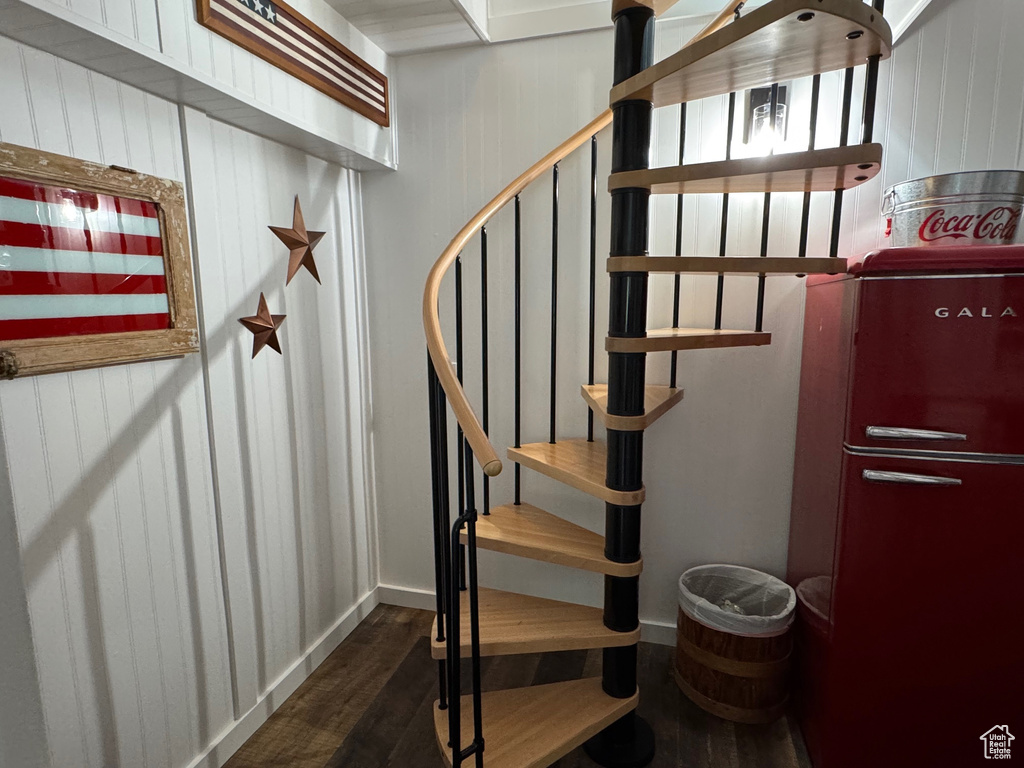 Stairway featuring wood finished floors and baseboards