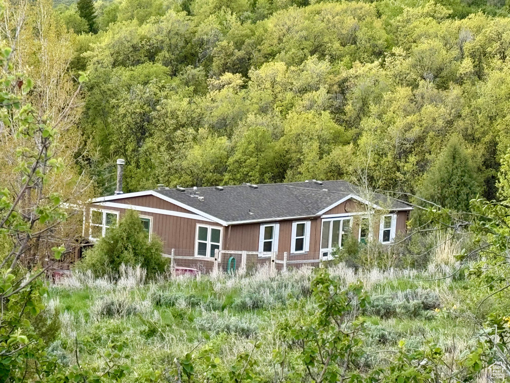 View from above of property featuring a heavily wooded area