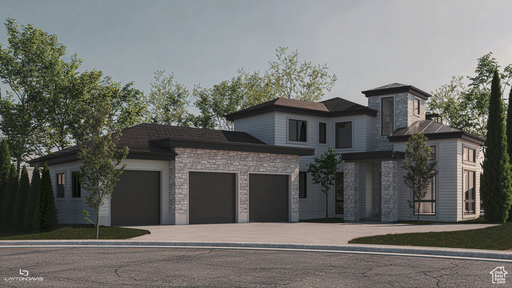 View of front of house featuring stone siding, an attached garage, and driveway