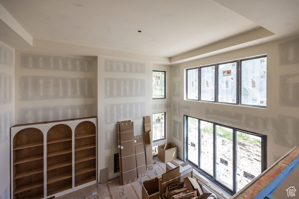 Living area with plenty of natural light and a tray ceiling