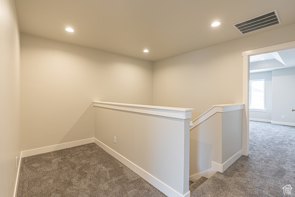 Corridor with carpet floors, an upstairs landing, recessed lighting, and baseboards