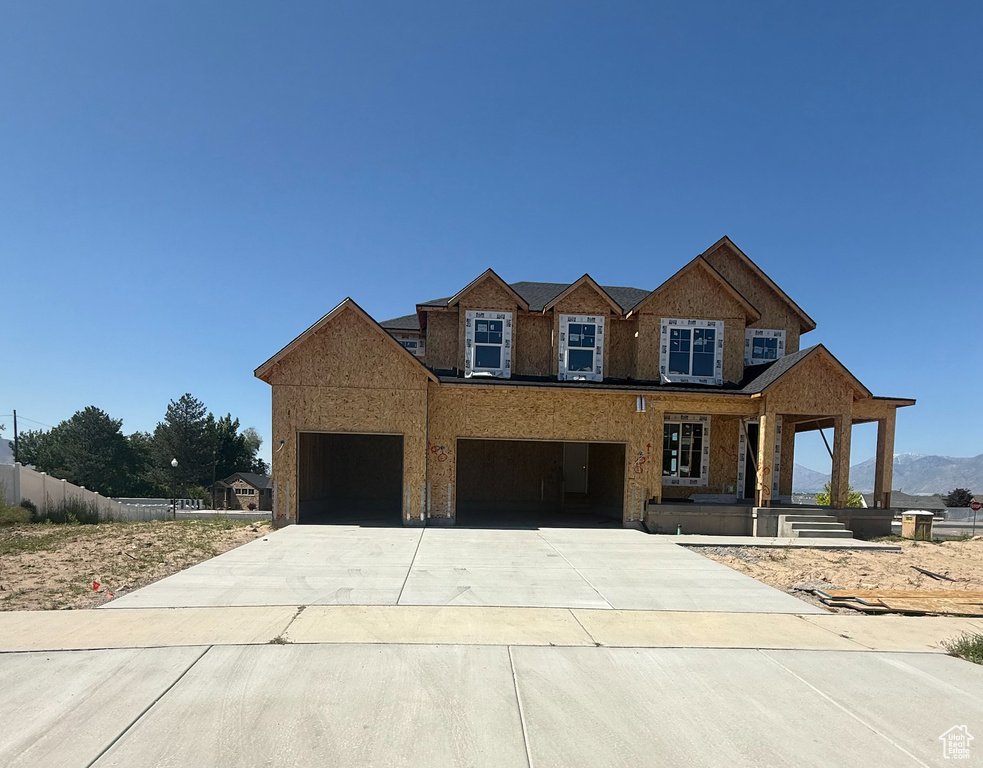View of front of property featuring driveway and an attached garage