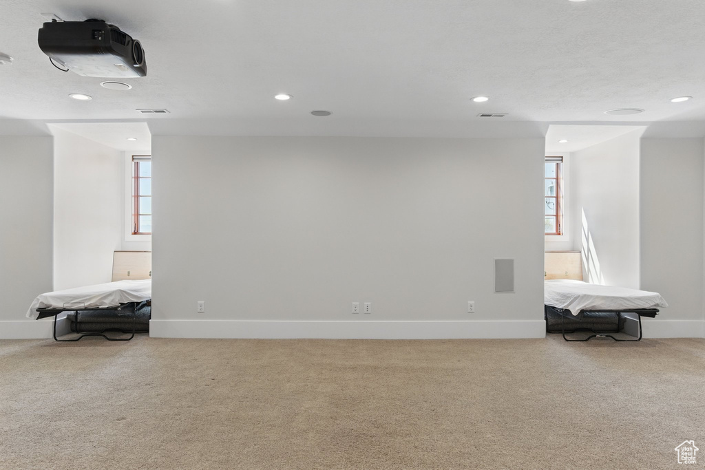 Basement with carpet flooring, baseboards, and recessed lighting