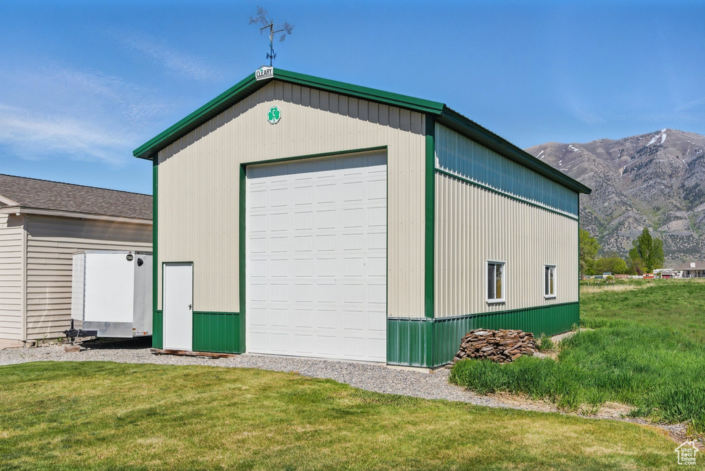View of outbuilding with a mountain view and an outdoor structure