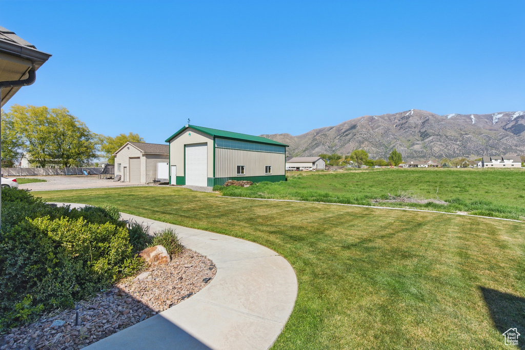View of yard featuring a mountain view and an outbuilding