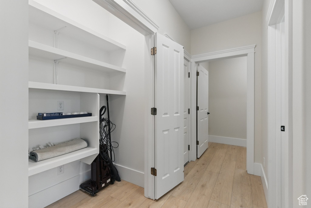 Hallway with light wood-type flooring