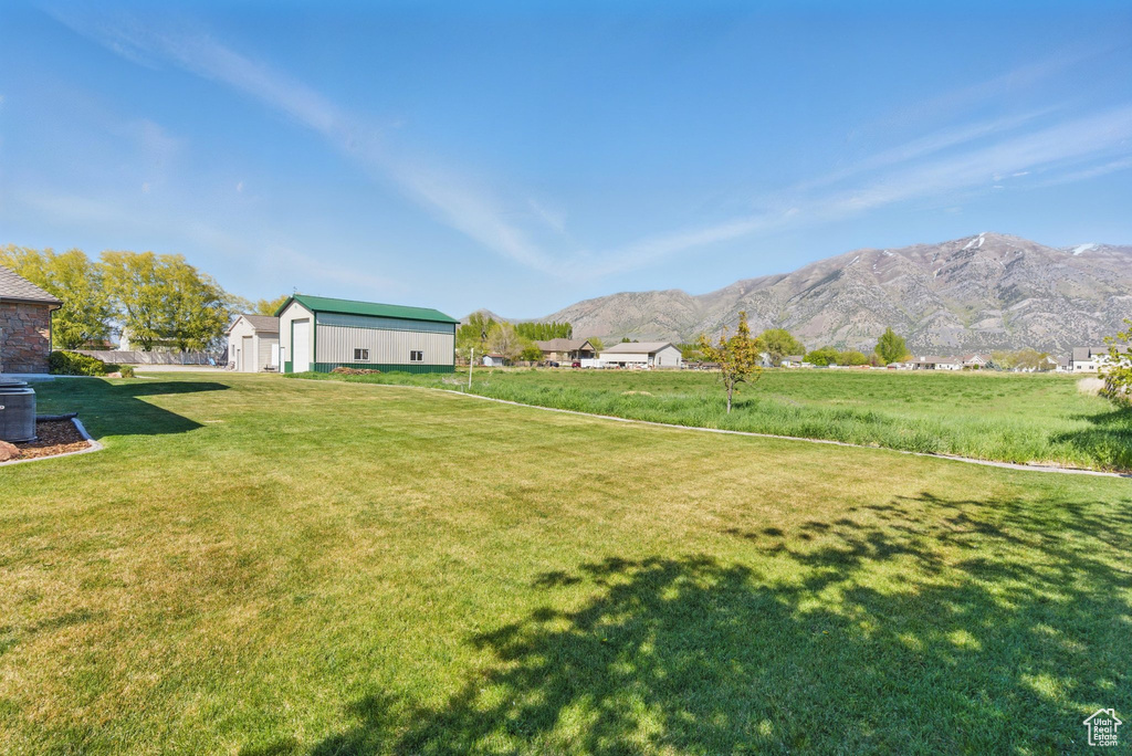 View of yard with a mountain view and an outbuilding
