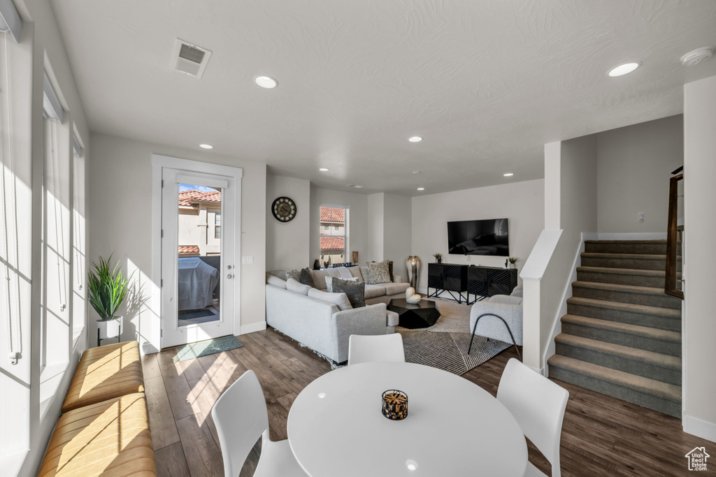 Living room featuring wood finished floors, stairway, recessed lighting, and baseboards