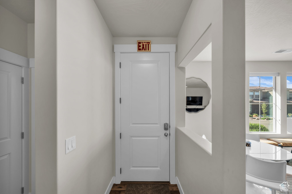 Entryway with dark wood-style flooring and baseboards