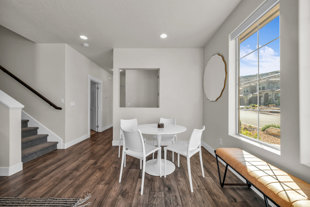 Dining room with plenty of natural light, wood finished floors, baseboards, and recessed lighting