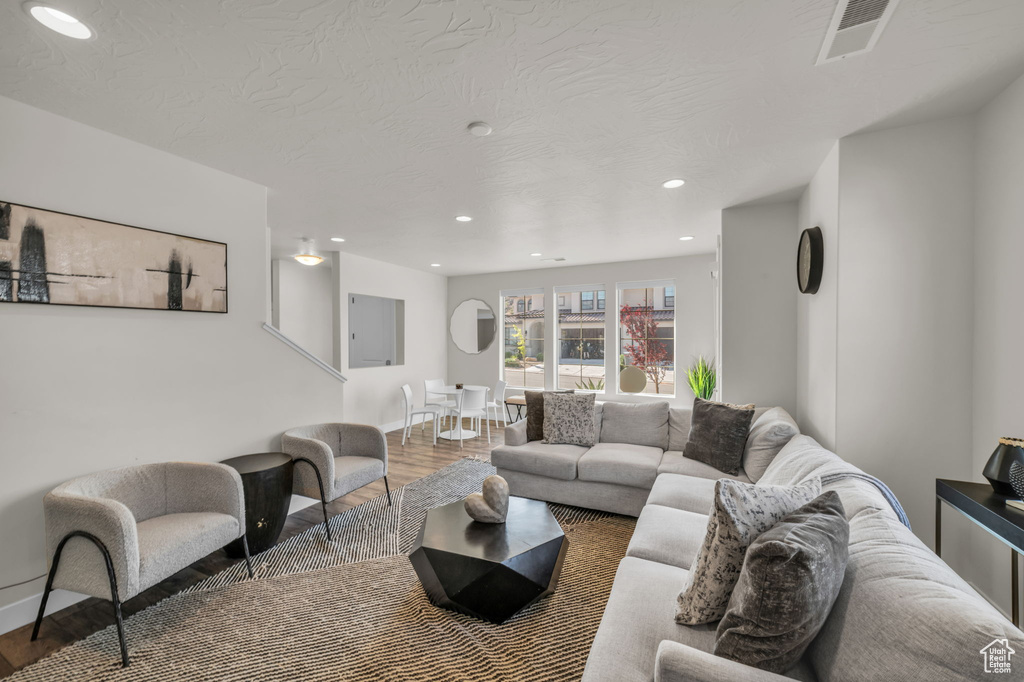 Living room featuring wood finished floors, recessed lighting, and baseboards