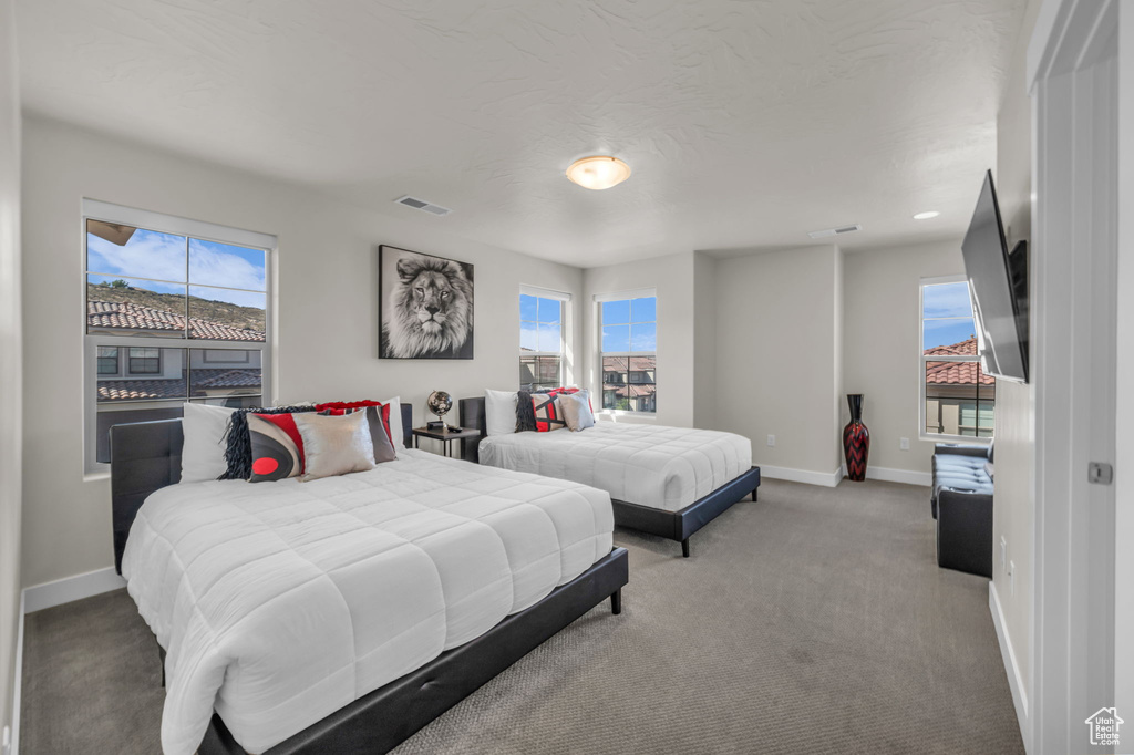 Carpeted bedroom featuring baseboards
