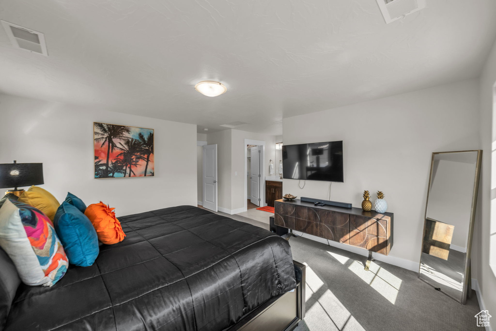 Carpeted bedroom featuring baseboards