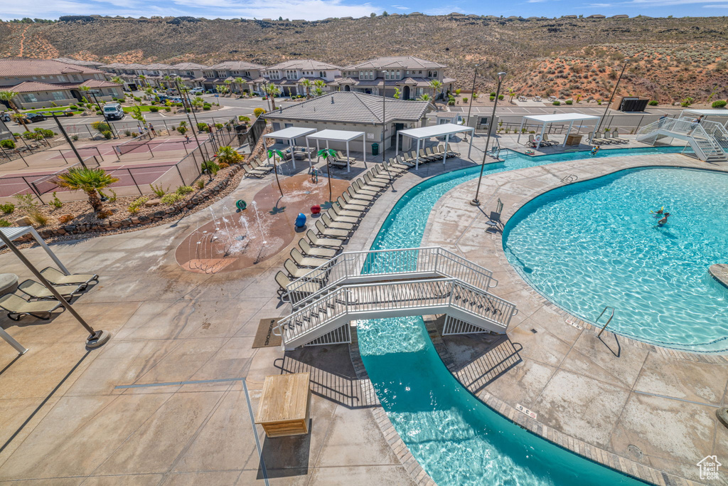 Community pool with a mountain view, a patio, and a residential view