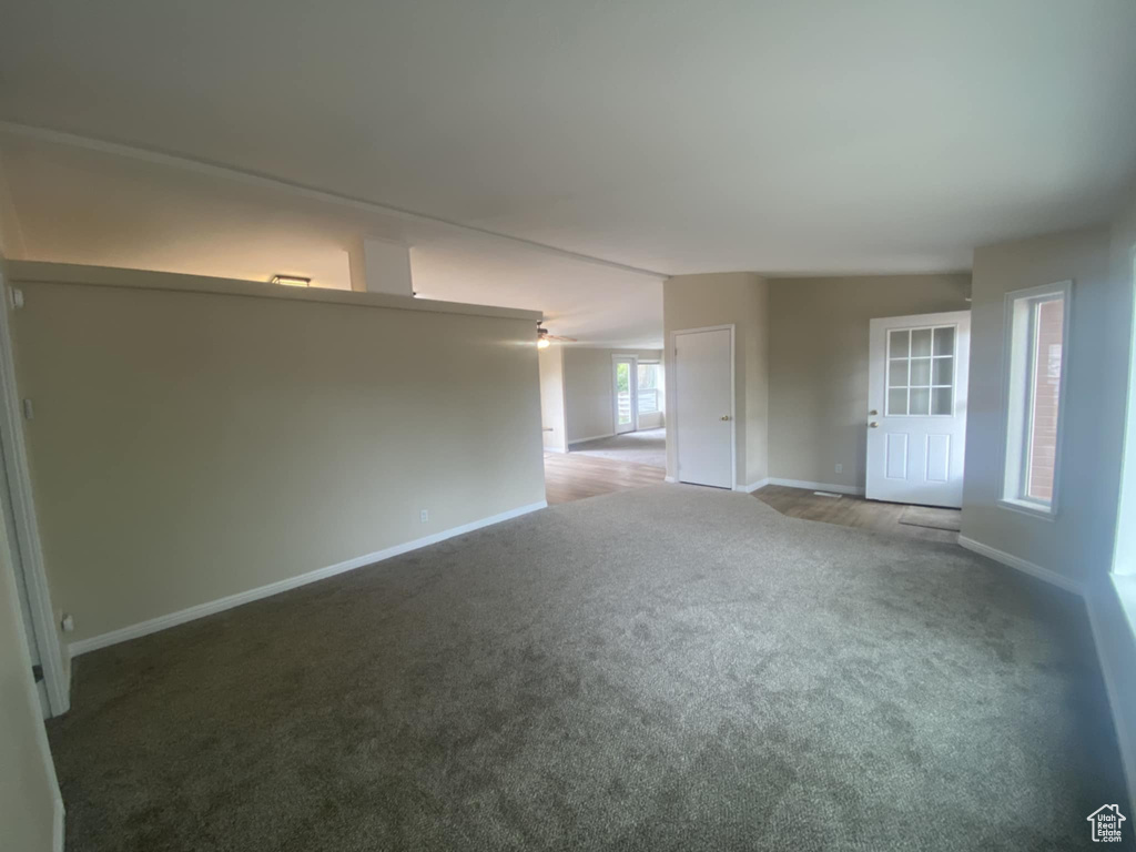 Carpeted empty room featuring baseboards