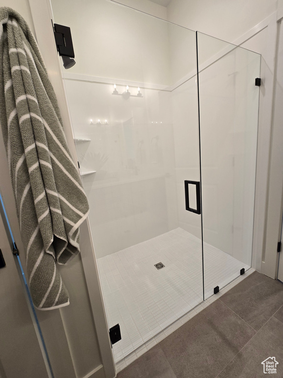 Full bath featuring a shower stall and tile patterned floors