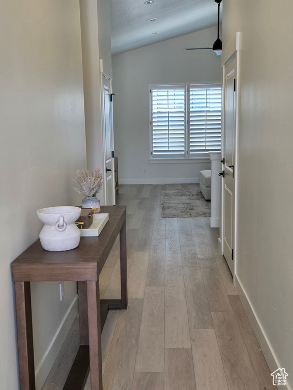 Hall featuring light wood-type flooring and baseboards