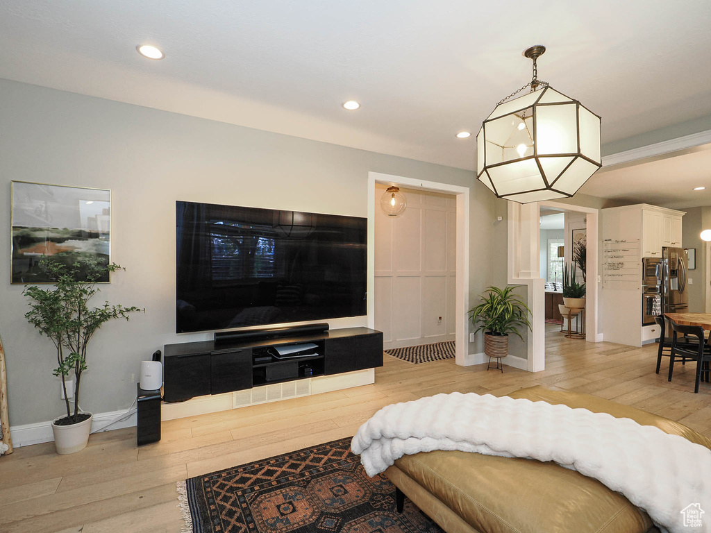 Living area featuring light wood-style floors, recessed lighting, and baseboards