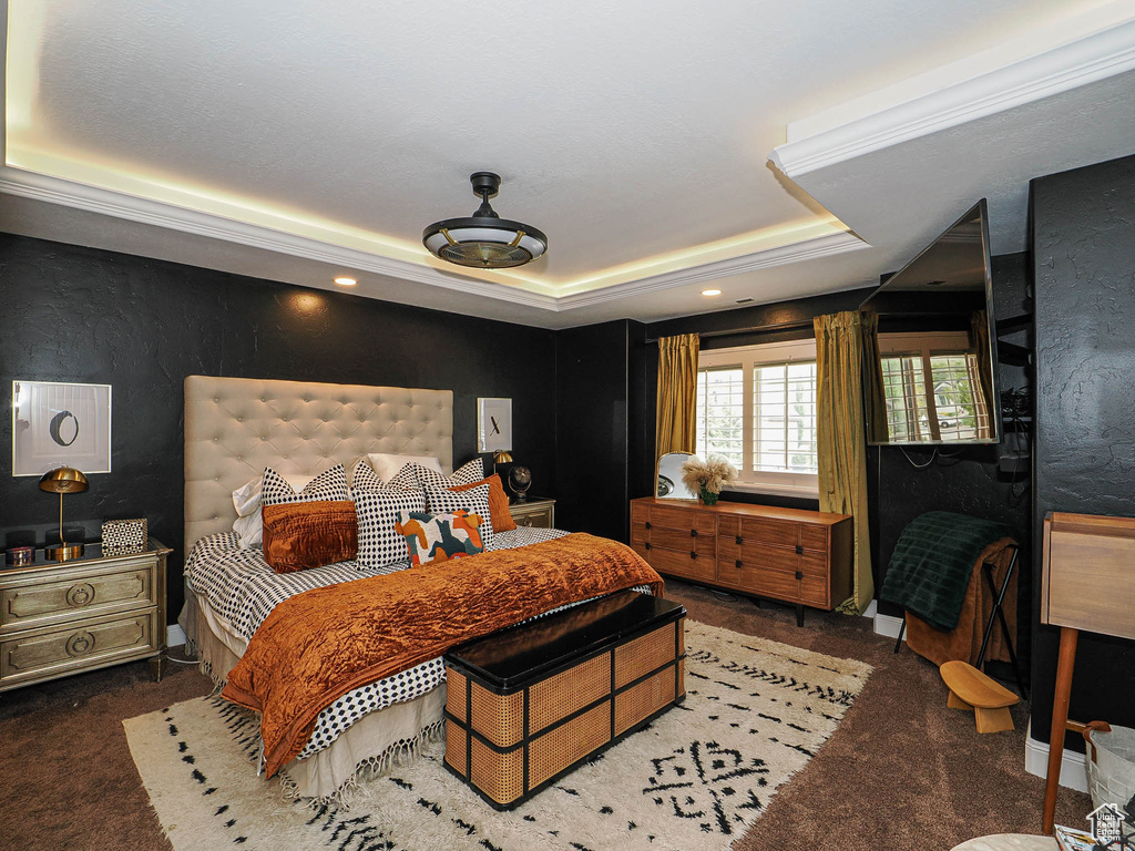 Bedroom with carpet flooring, a raised ceiling, and recessed lighting