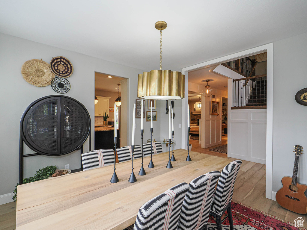 Dining area featuring wood finished floors and stairs