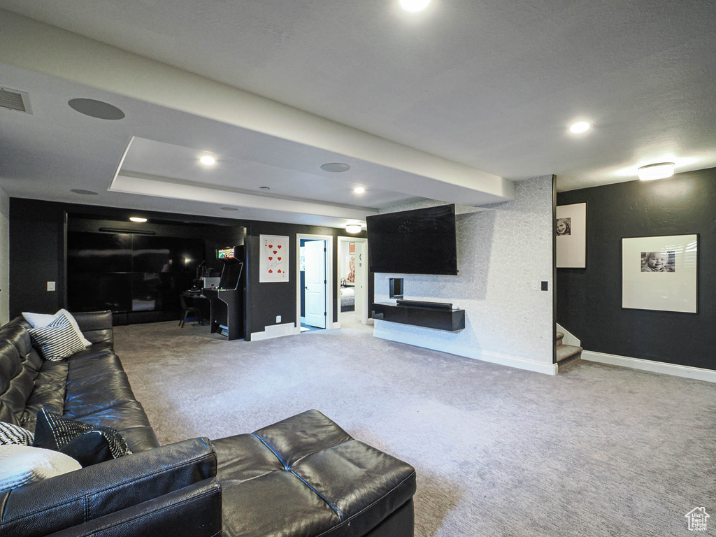 Carpeted living area featuring baseboards and recessed lighting