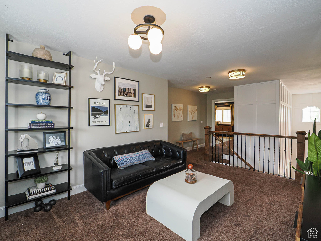 Carpeted living area featuring baseboards