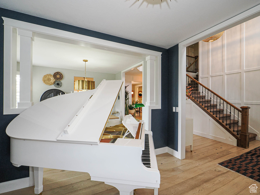 Stairway with hardwood / wood-style flooring and baseboards