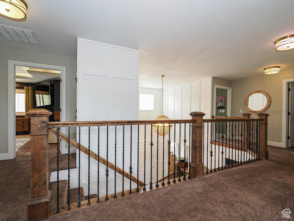 Hall featuring carpet flooring, an upstairs landing, and baseboards