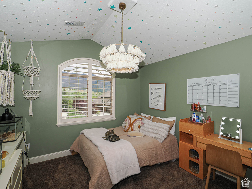 Bedroom with vaulted ceiling, a chandelier, and carpet flooring