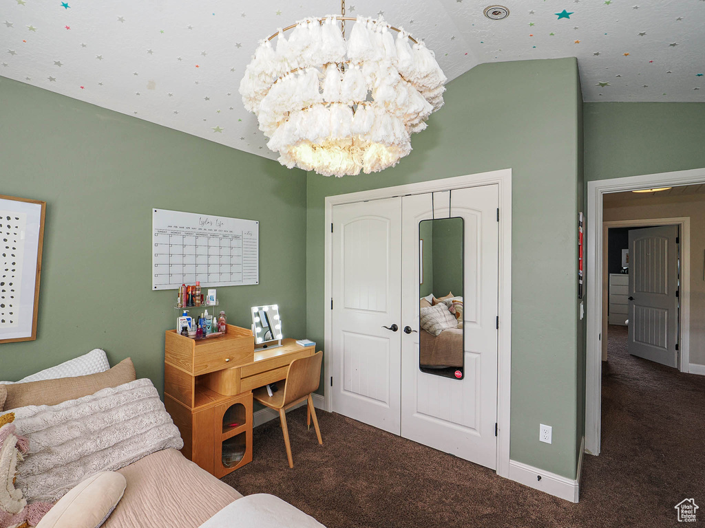 Carpeted bedroom featuring a chandelier, lofted ceiling, a closet, and baseboards