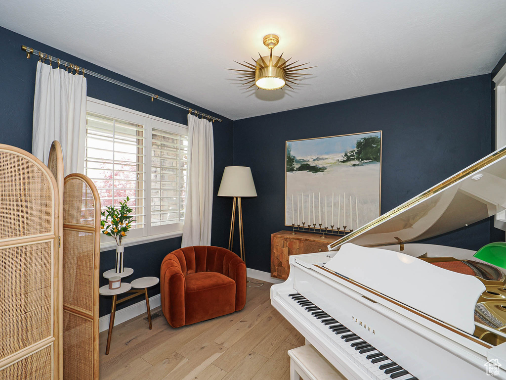 Sitting room with hardwood / wood-style floors and baseboards