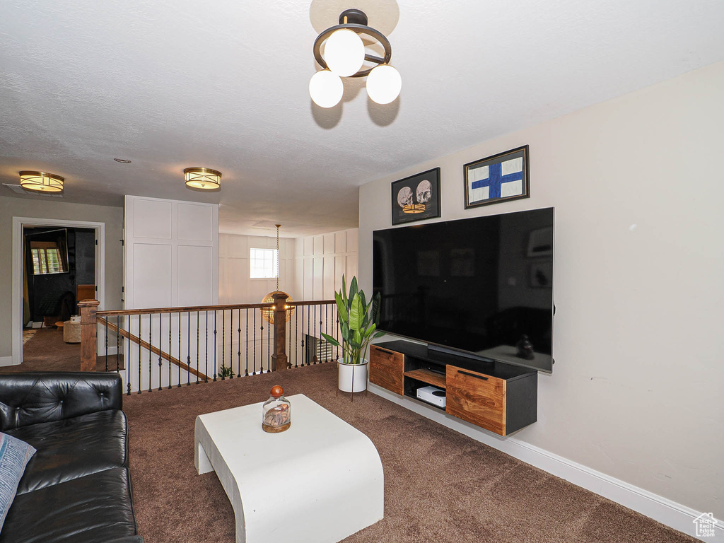Carpeted living room with baseboards