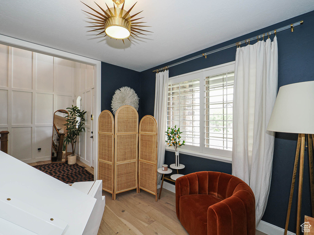 Living area featuring light wood-type flooring and baseboards