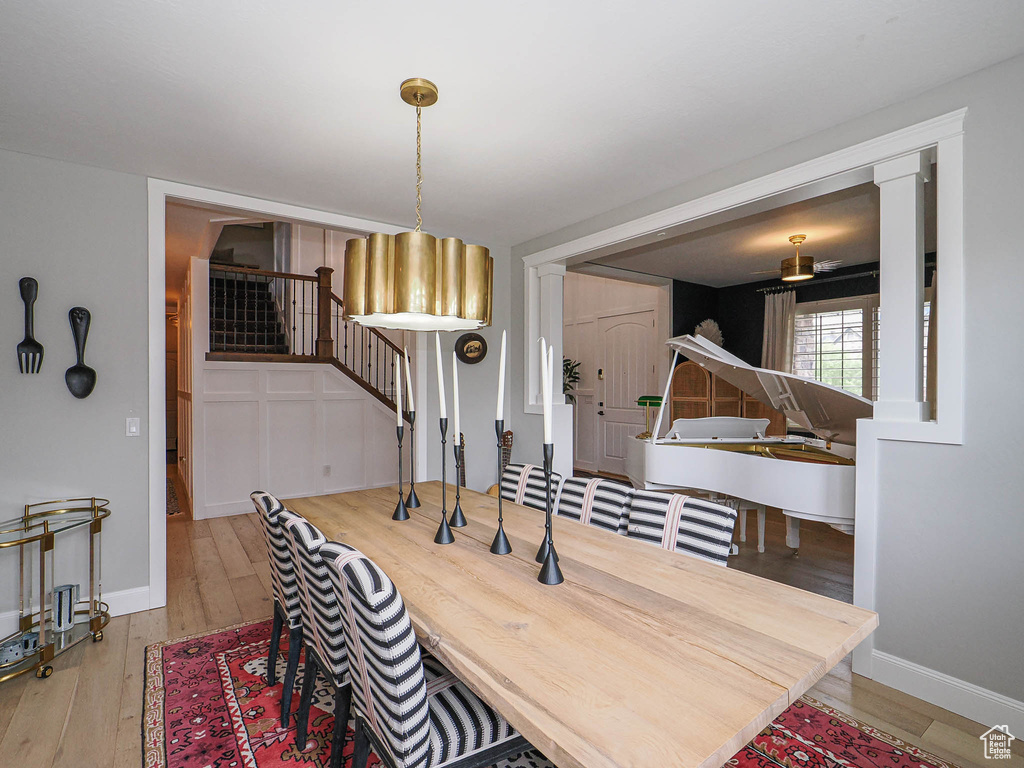 Dining room featuring wood finished floors, stairway, and baseboards
