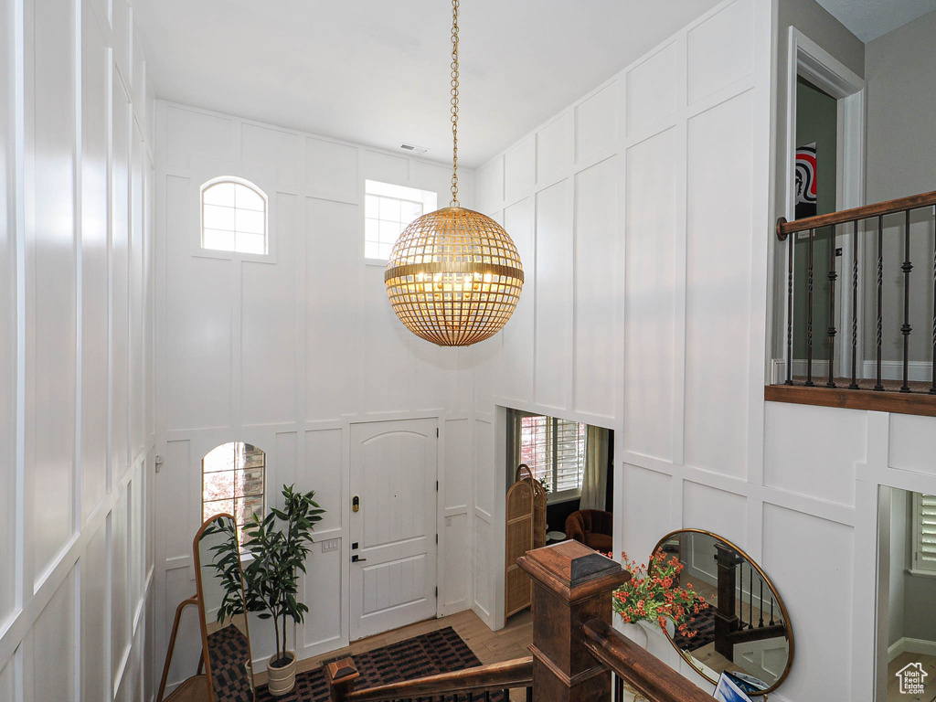 Entryway with a decorative wall and a chandelier