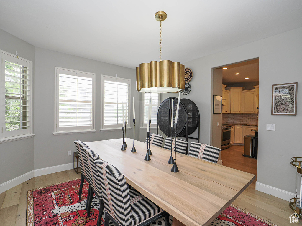 Dining area with light wood-type flooring and baseboards