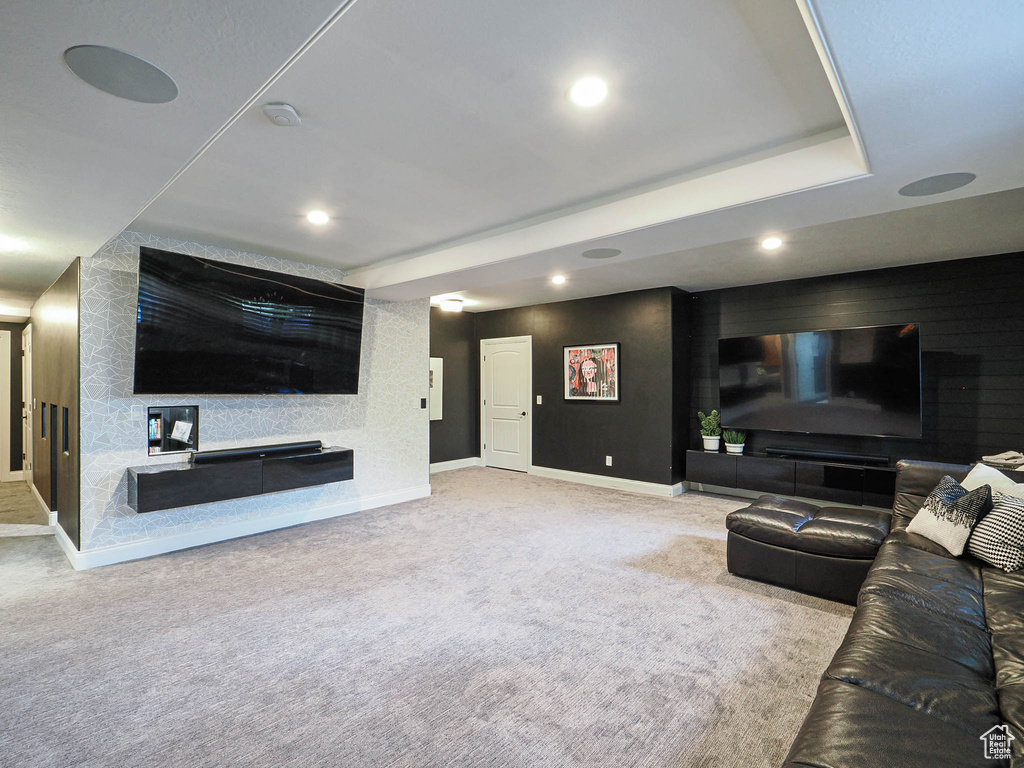 Carpeted living room with baseboards and recessed lighting