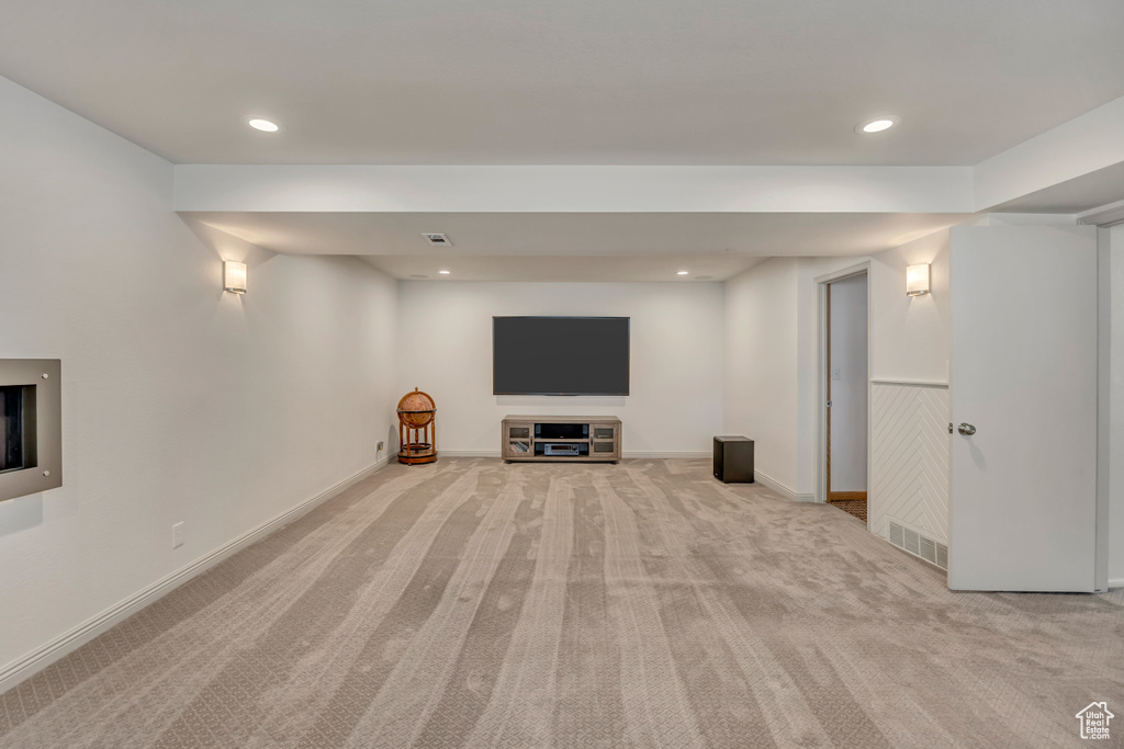 Basement with light colored carpet, recessed lighting, and baseboards