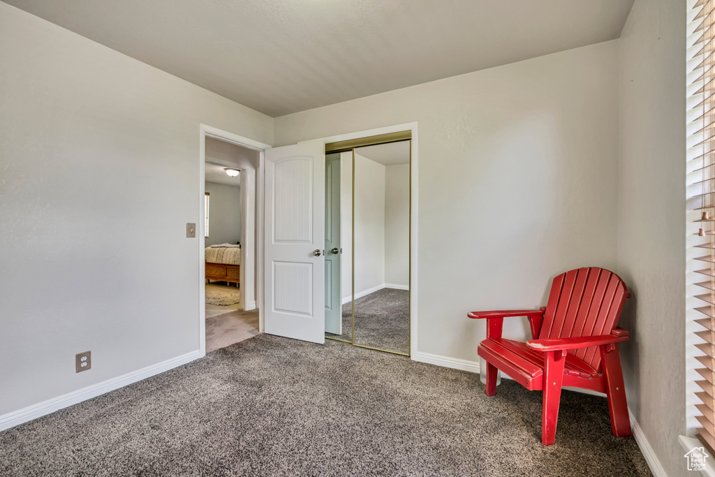Living area with carpet and baseboards