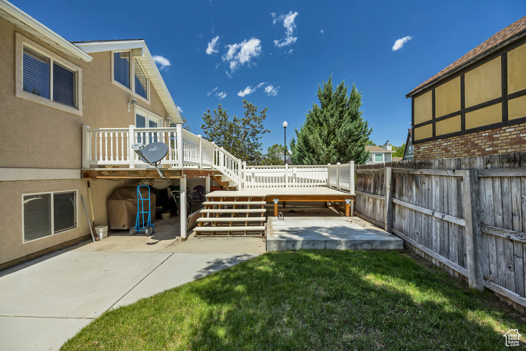 View of yard featuring a patio, a wooden deck, and stairway