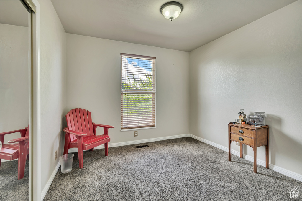 Living area with carpet and baseboards