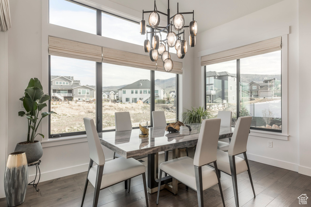 Dining area with a chandelier, baseboards, and plenty of natural light