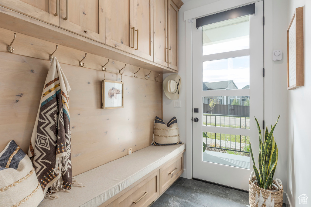 Mudroom featuring dark stone finish flooring