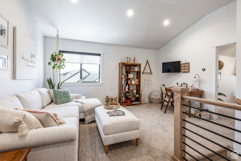 Living room featuring light carpet, lofted ceiling, and recessed lighting
