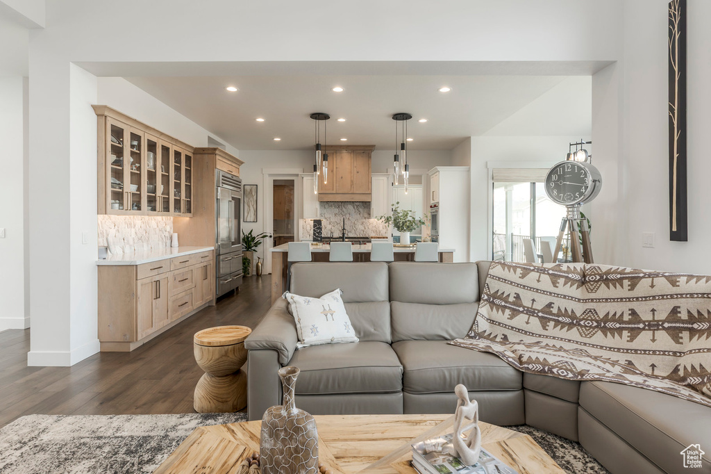 Living area featuring dark wood finished floors, recessed lighting, and baseboards