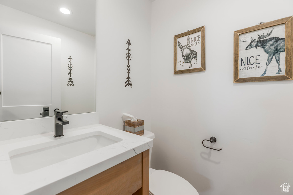 Half bathroom featuring toilet and vanity