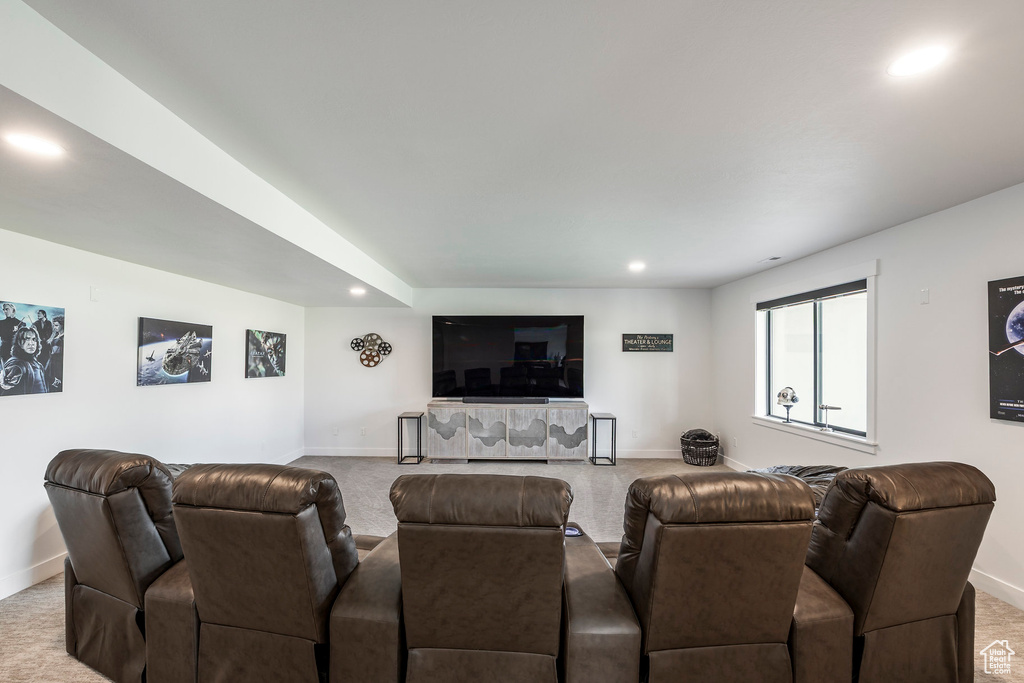Carpeted living room featuring recessed lighting and baseboards