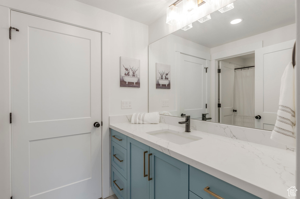 Bathroom featuring vanity and recessed lighting
