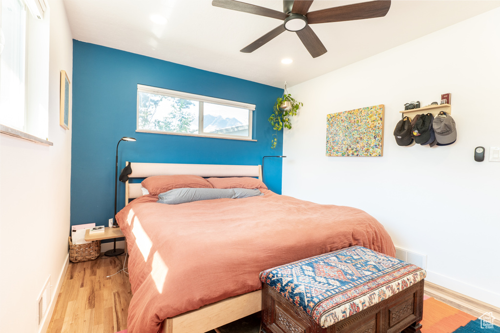 Bedroom with wood finished floors, ceiling fan, baseboards, and recessed lighting