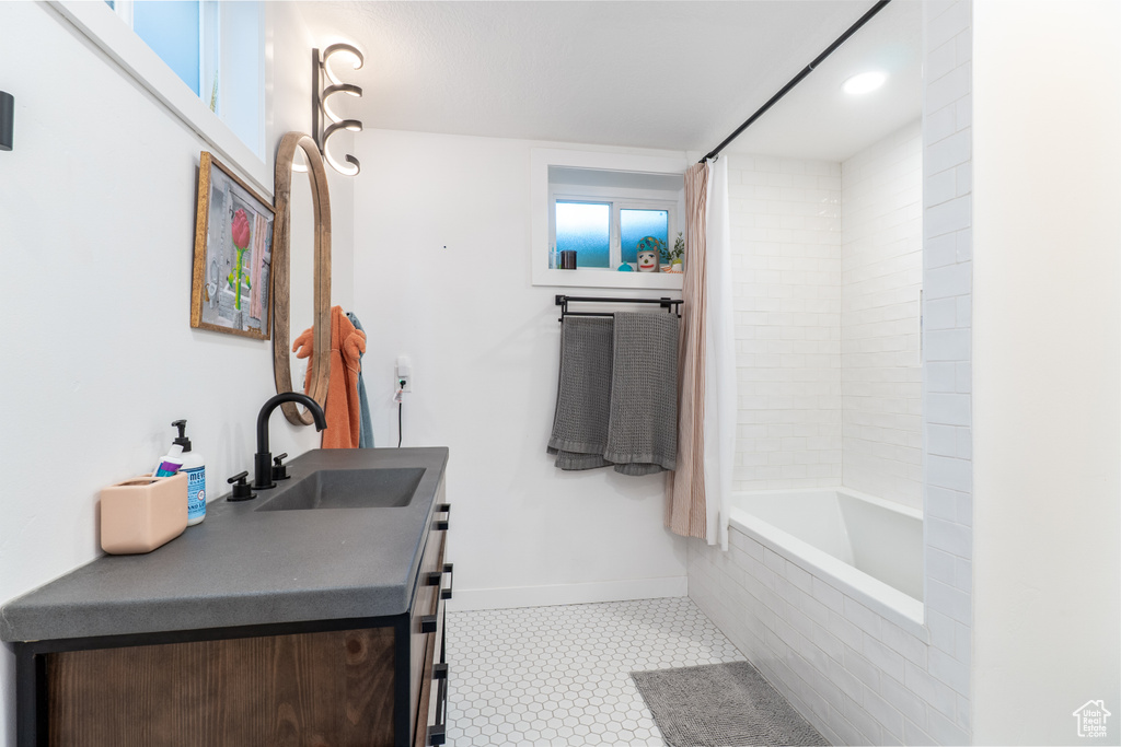 Full bath with tile patterned floors, baseboards, vanity, shower / tub combo, and recessed lighting